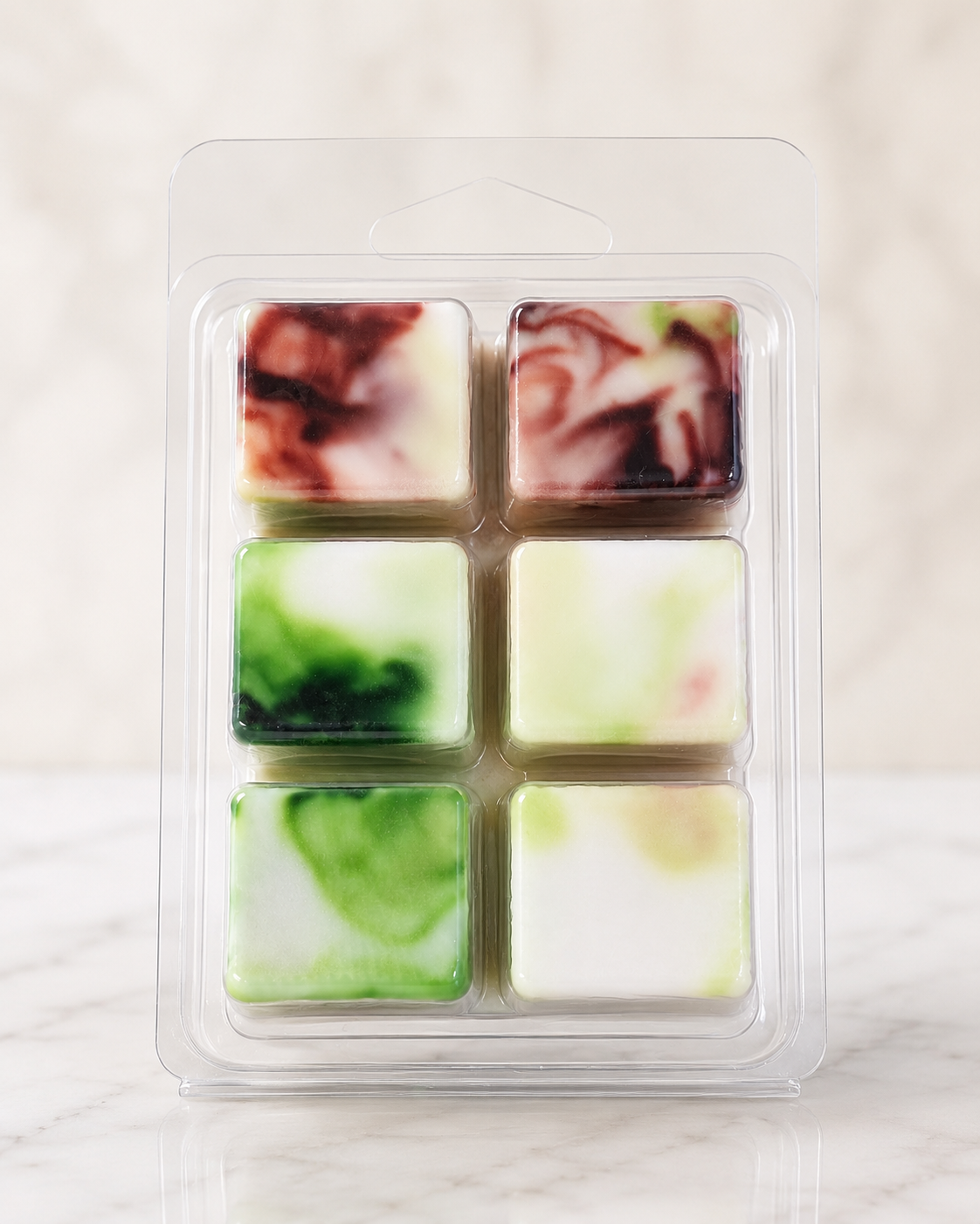 Six square wax melts in a clear plastic packaging on a light background