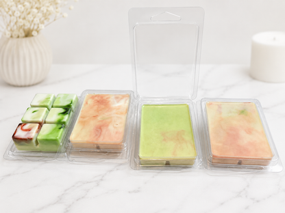 Four rectangular soap bars in clear packaging on a white surface.